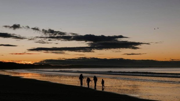 Gerlach family members walk along the beach near Riverton on the Te Araroa Trail.