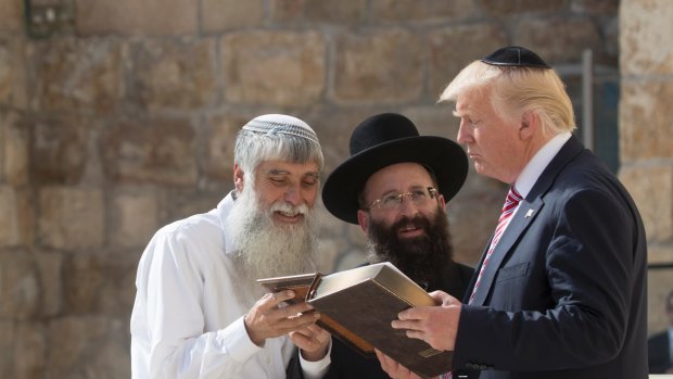 President Donald Trump receives a Book of Psalms from Shmuel Rabinovitch during a visit the Western Wall in Jerusalem in May.