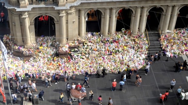  Tributes grow on the steps of the GPO building in Melbourne's Bourke Street. 