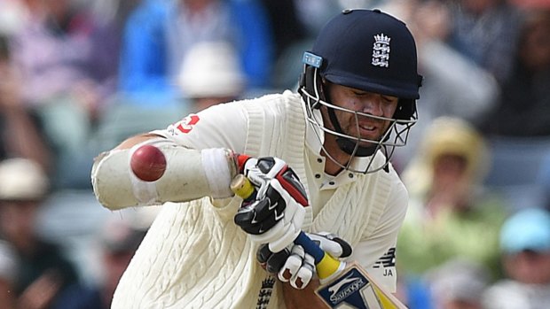 Beaten: James Anderson is hit by a ball from Pat Cummins.