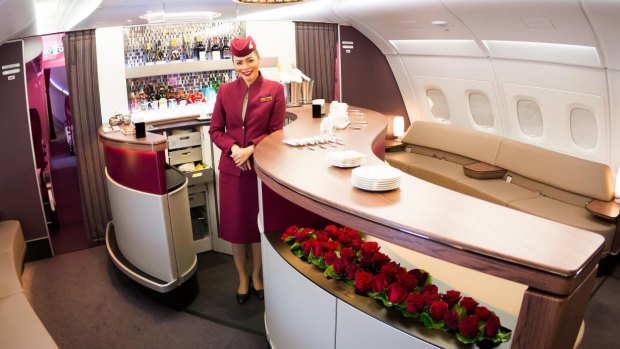 A Qatar Airways cabin crew member at the Airbus A380 First Class bar and  lounge.