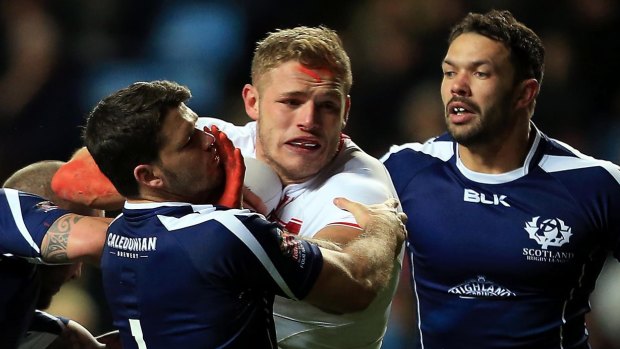 Bunny burst: George Burgess is tackled by the Scotland defence.