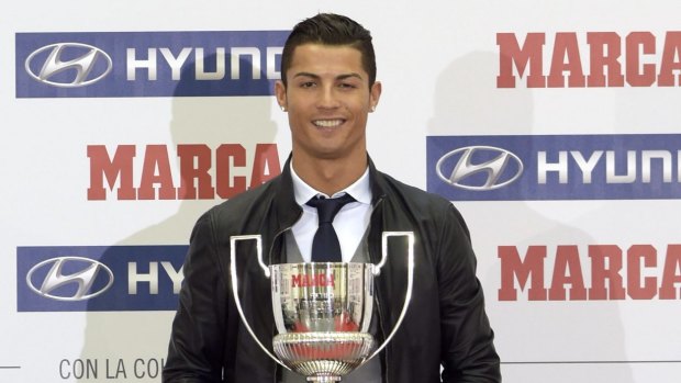 No Messi fan: Cristiano Ronaldo poses with the trophy for the best striker in La Liga on Monday.