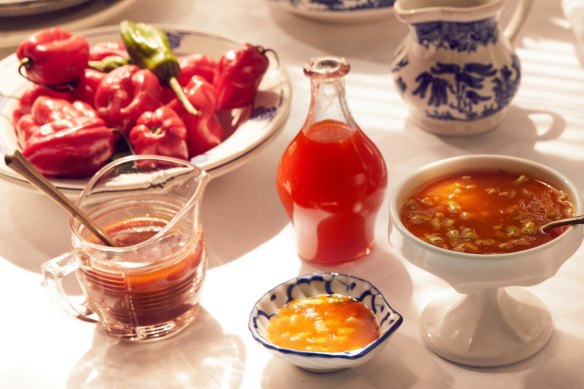 Fresh habanero chillies (left) are the base for these hot sauces including (from left to right) peach and jalapeno; charred habanero and garlic; tropical hot sauce (see recipe link below) and tomatillo verde.