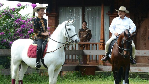 Changing horses: As chairman of Indonesia's Golkar Party, Setya Novanto moved from backing Prabowo Subianto, right, to supporting Indonesian President Joko Widodo, left.
