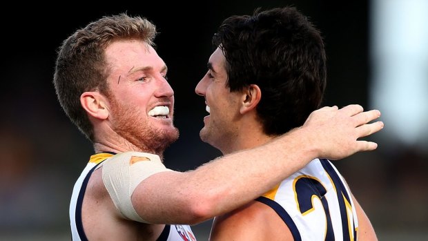 Xavier Ellis and Matt Rosa of the Eagles celebrate a goal during the round 20 AFL match between the Fremantle Dockers and the West Coast Eagles at Domain Stadium.