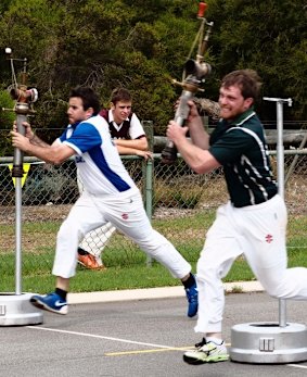 Two male competitors throw themselves into the Hydrant Race.