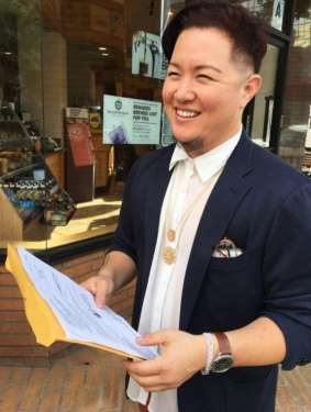 Californian resident A.T. Furuya holding a nonbinary gender court order.