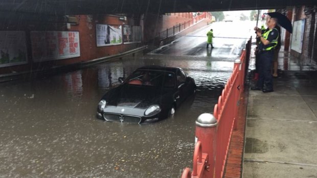 A Maserati stricken in floodwater on Victoria Street, Seddon on Saturday.