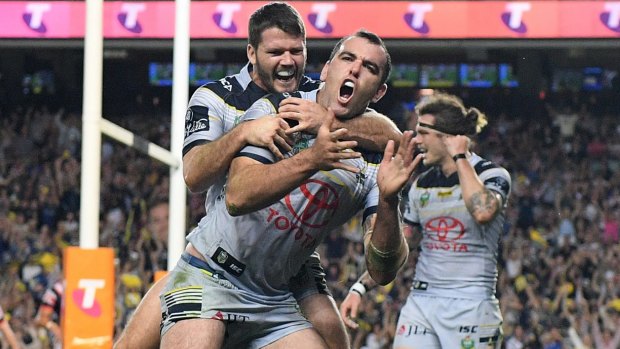 Game over: Kane Linnett scores for the Cowboys against the Roosters.
