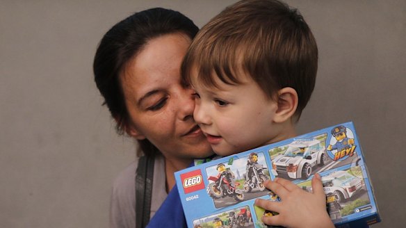Sabine Atlaoui, the wife Serge Atlaoui, holding their son Yasen Atlaoui (right) while they wait to visit him on Nusakambangan prison island where the Indonesian authorities plan to execute him.
