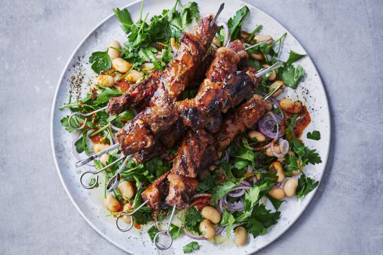 Portuguese beef espetada skewers with peri peri and warm bean salad.