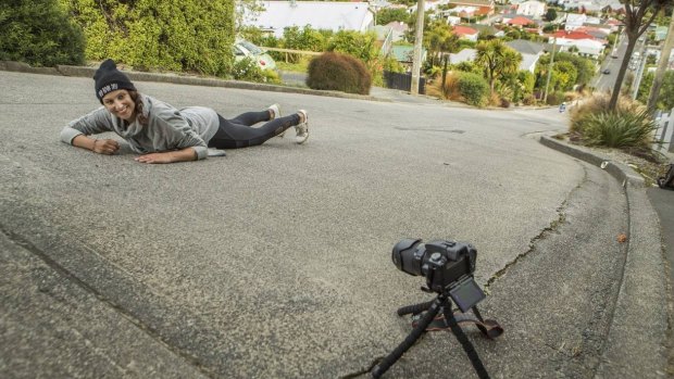 Marine Chabrol, a tourist from France, lies in the middle of Baldwin St, Dunedin. 