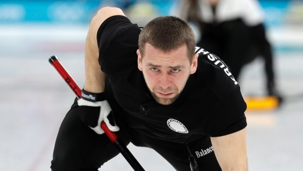 Russian curler Aleksandr Kruhelnitckii sweeps the ice en route to bronze in the mixed doubles.