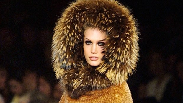 A model wears a  coat with its fur matching hood.