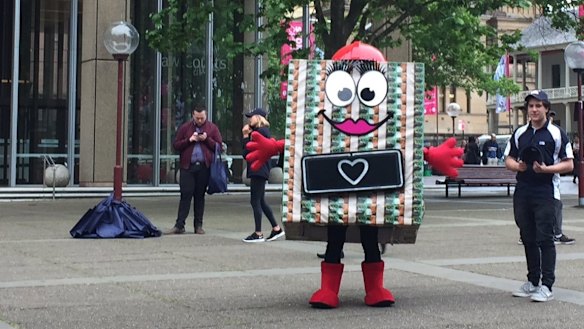 A Nine publicity crew hands out merchandise outside the Federal Court in Queen's Square.