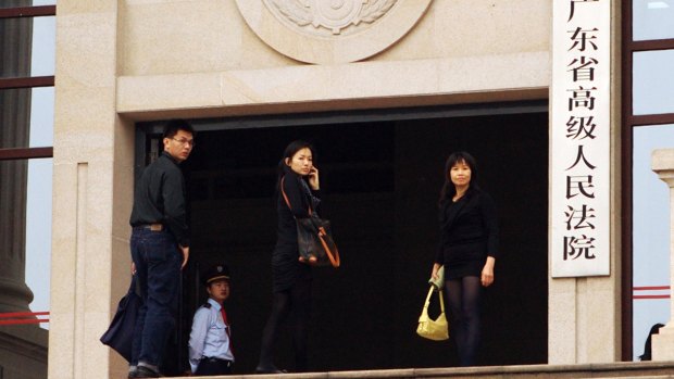 Matthew Ng's wife Niki Chow, his older sister and  younger brother at Guangdong Supreme Court in March 2012.