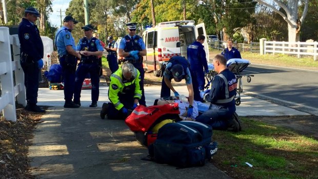 The CareFlight team treats a tradesman who was attacked by three dogs at a property in Kenthurst.