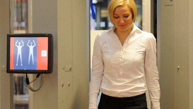 A woman walks through a body scanner at Hamburg airport, Germany. Fuel Matrix is look for 'discreet' ways to weigh passengers at airports before they board.