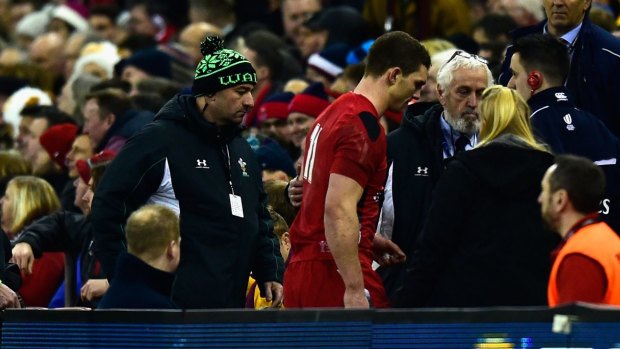 Mandatory test: George North  leaves the field for treatment.