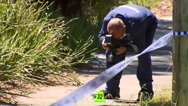 Forensic police study the blood trail at Westfield Donvale.