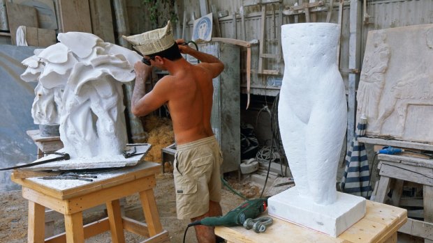 A sculptor shows off his skills at one of the 90 marble workshops found in Pietrasanta, Italy. 