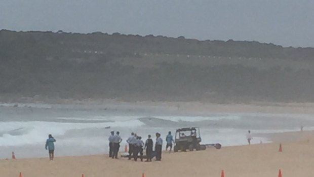 Police recover a body from the surf in the search for Tui Gallaher, 14, at Maroubra Beach on Friday.