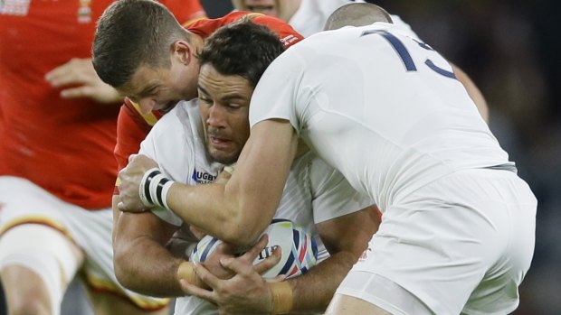 Wrapped up: England's Brad Barritt is tackled against Wales at Twickenham.