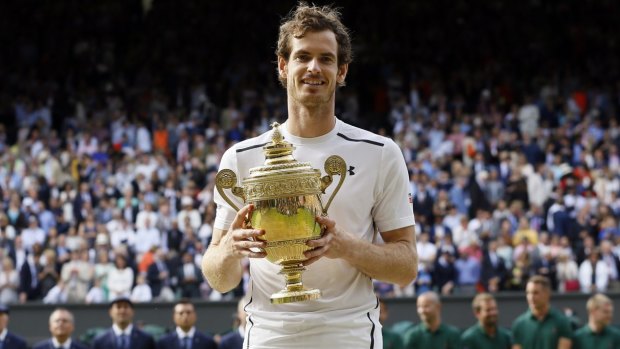 Home favourite Andy Murray holds the Wimbledon trophy for a second time.