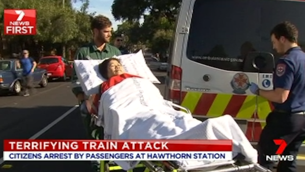 A woman is taken to hospital after the attack at Hawthorn station on Thursday.