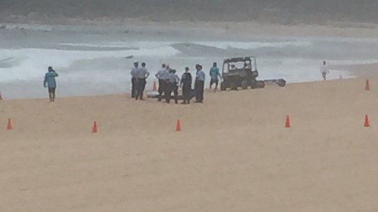 Police recover a body from the surf in the search for Tui Gallaher, 14, at Maroubra Beach on Friday.
