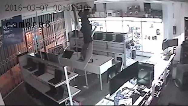 A man lowered himself down through the ceiling of a Chermside computer business in an attempted burglary.