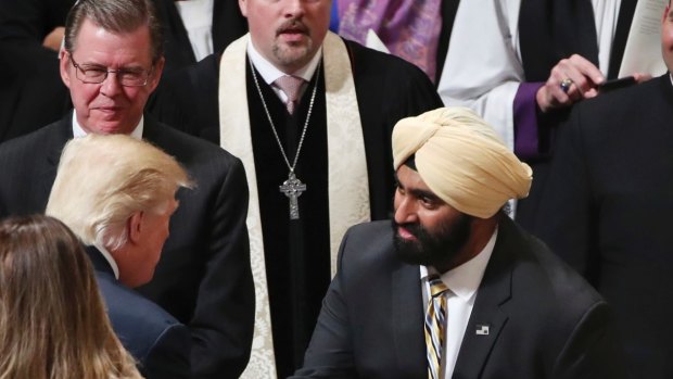 US President Donald Trump, left, greets an Indian Sikh, during a National Prayer Service at the National Cathedral, in Washington in January.