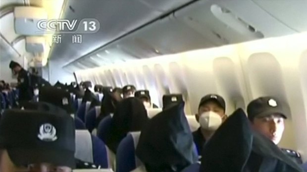 With black hoods hiding their faces, the Uighurs were deported from Thailand to China.