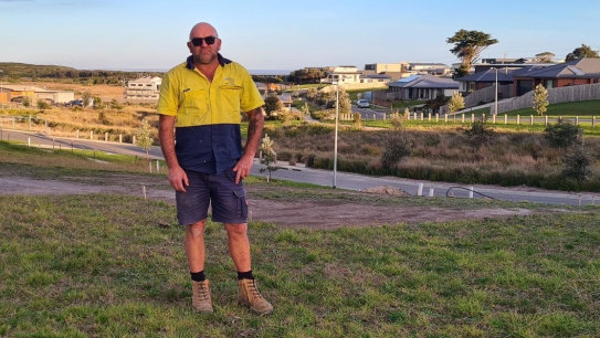 50 岁的沃利·伯恩斯 (Wally Burns) 在他位于基尔昆达 (Kilcunda) 的空置街区，由于房屋建筑商 Langford Jones Homes 的倒闭，他现在正在出售该街区。