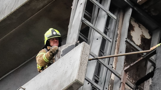 Firefighters inspect the damage at Melbourne’s Neo 200 building.