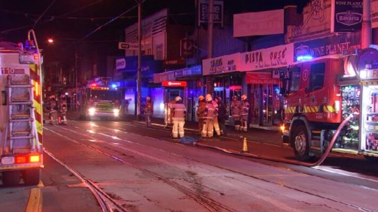 Firefighters outside a vape and tobacco store on Sydney Road, Coburg on June 7.