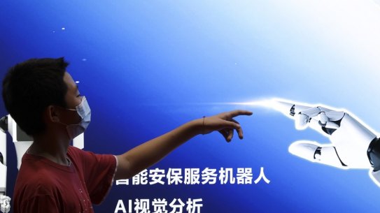 BEIJING, CHINA - AUGUST 18: A boy points to the AI robot Poster during the 2022 World Robot Conference at Beijing Etrong International Exhibition on August 18, 2022 in Beijing, China. The 2022 World Robot Conference kicked off on Thursday in Beijing. (Photo by Lintao Zhang/Getty Images) *** BESTPIX ***