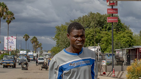 A pedestrian carries bottles containing fuel amid protests over fuel prices.