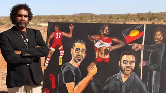 Artist Vincent Namatjira with his Archibald Prize-winning portrait of himself and Adam Goodes.