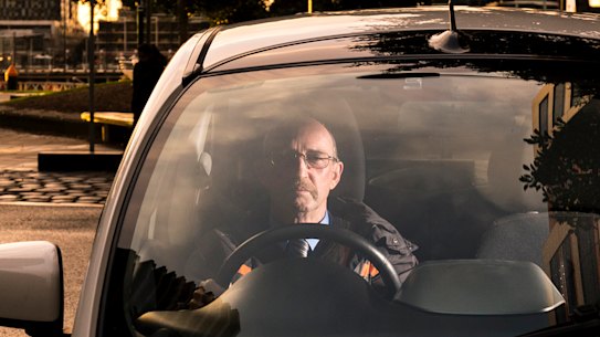 Electric car owner Daryl Budgeon in his 2012 Misubishi i-Miev, 