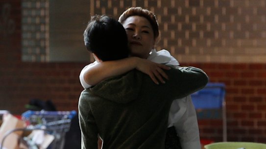 A protester hugs a social worker inside the campus of Hong Kong Polytechnic University in Hong Kong on Friday.