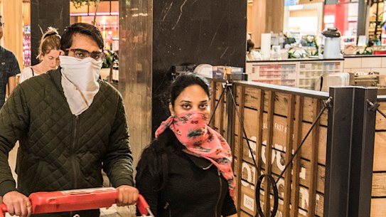 Shoppers at the Macquarie Centre take their own precautions to avoid the spread of coronavirus. 