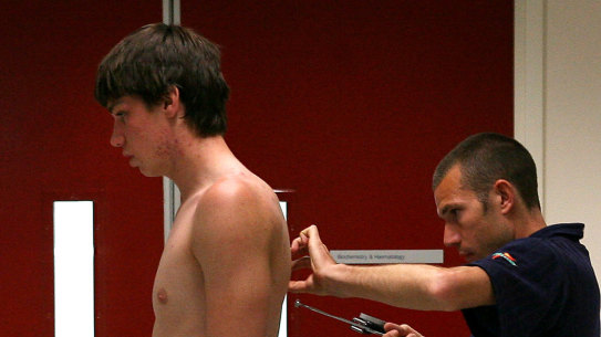 Former Blue Matthew Kreuzer has his skin folds checked at a draft camp in 2007.