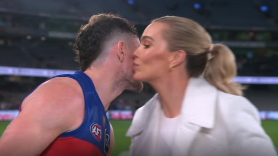 Brisbane player Lachie Neale leans in to give Channel 7 reporter Abbey Holmes a kiss at Marvel Stadium last Friday.