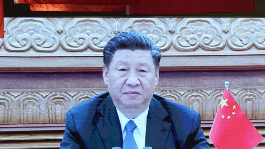 Chinese President Xi Jinping appears on screen near a photo showing him in a mask highlighting China’s fight against COVID at the Museum of the Community Party of China in Beijing in October.