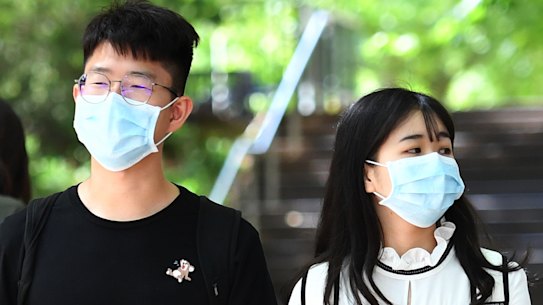 Stan Dong and Angela Hung wore masks on Melbourne University campus at the request of their parents. 