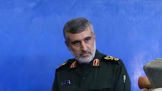 Head of the Revolutionary Guard's aerospace division General Amir Ali Hajizadeh looks at debris from what the division describes as the US drone which was shot down in Tehran in 2019.