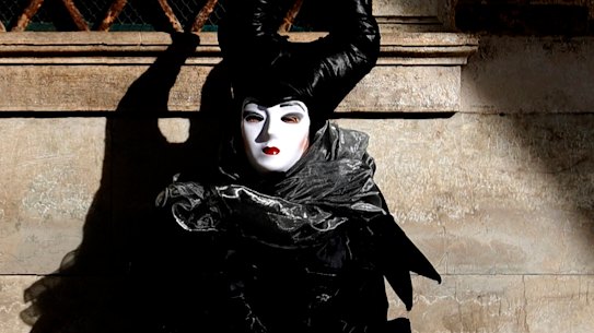 A woman in full costume for Venice Carnival, which was on Sunday cancelled due to the coronavirus outbreak.