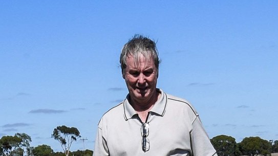 Farmer Adrian McMaster points to rocks he accidentally removed from an ancient Aboriginal stone arrangement in Lake Bolac.